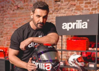 John Abraham Partners With Aprilia India As Their Brand Ambassador; Photographed With A Superbike Valued At Rs. 4.10 Lakh