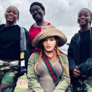 MADONNA AND TWINS, ESTERE AND STELLA, RETURN VISIT COUNTRY WHERE THEY WERE BORN
