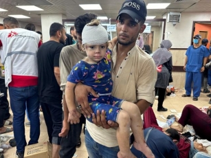 Photos: Victims Of Israeli Attack On Central Gaza Overwhelm Hospital