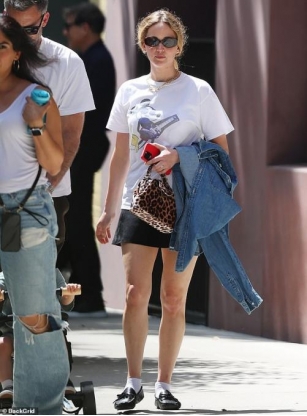 Jennifer Lawrence Wears A Mickey Mouse Shirt And Black Miniskirt As She Enjoys Family Stroll With Son Cy, Two, And Husband Cooke Maroney In NYC
